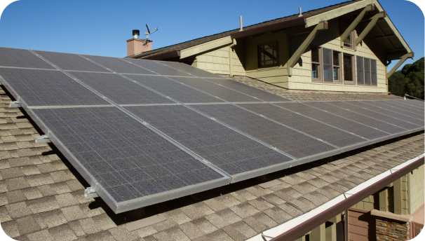 Image of solar panels on a roof of a green cape house