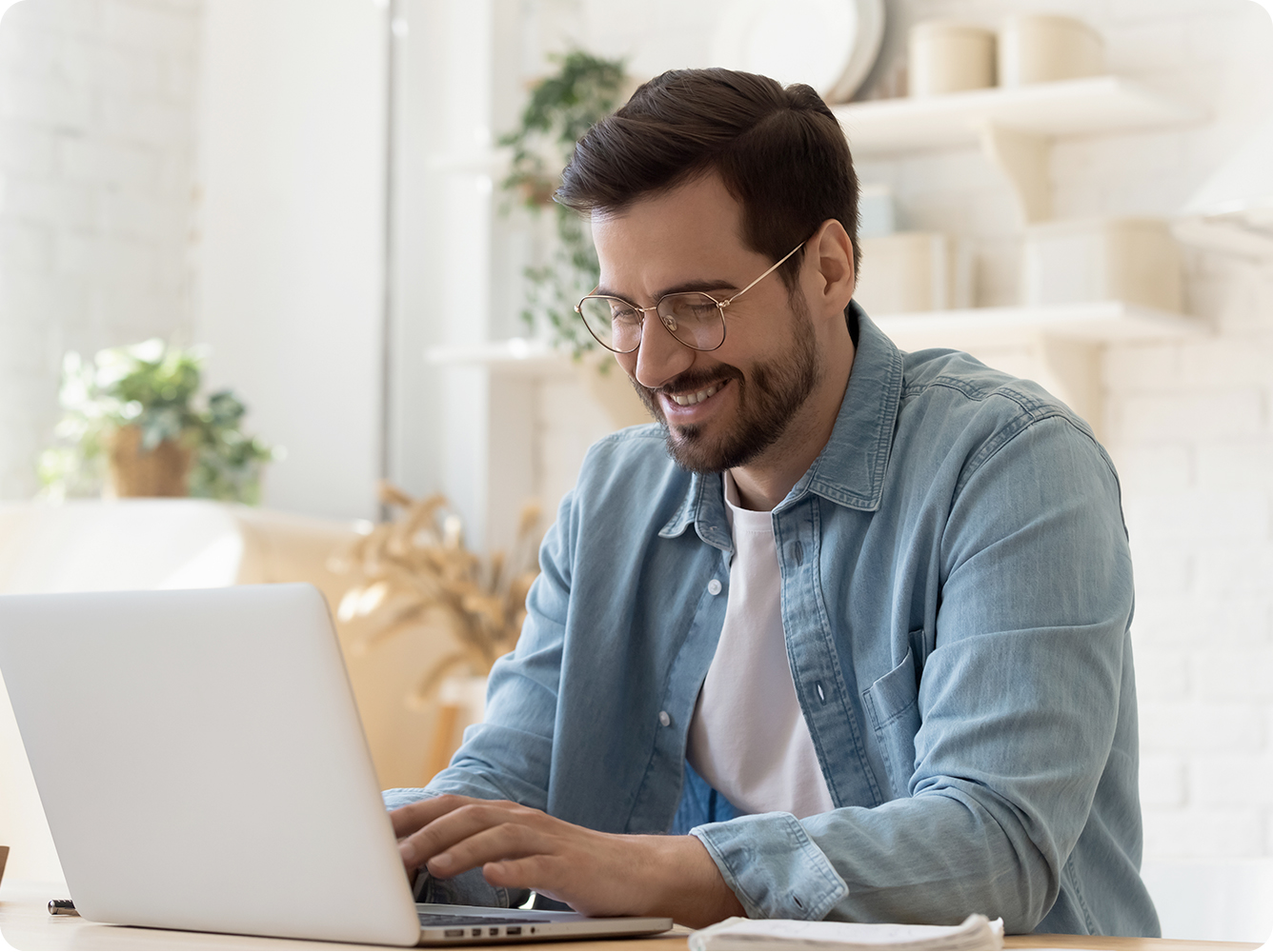 Young man smiling looking at laptop