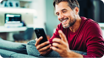 man looking at his phone smiling